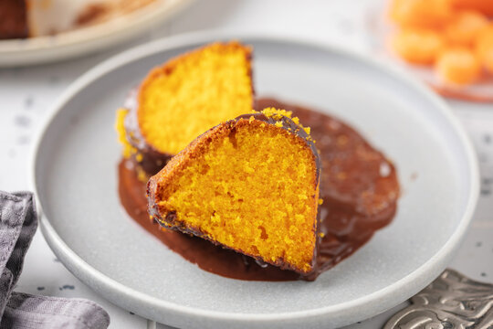 Brazilian carrot cake, bolo de cenoura, with chocolate glaze on the plate. Dessert, baked, delicious. Two pieces