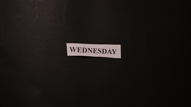 Wednesday Concept Message with Paper Note on Black Texture Surface