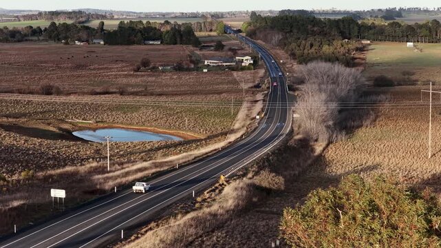 Aerial View of Vehicles Driving on Rural Highway Through Australian Countryside