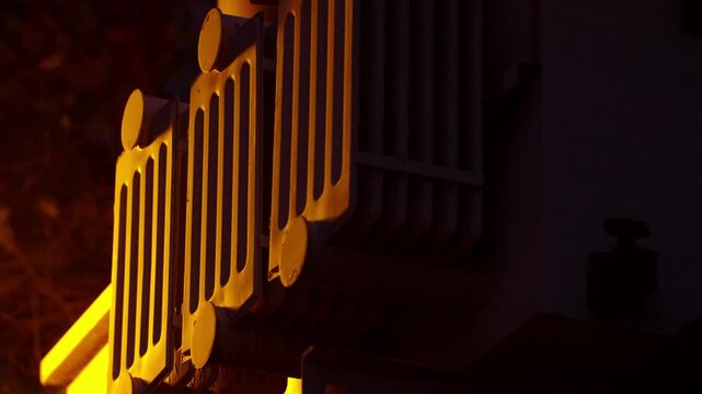Power Transformer Cooling Fins Lit by Streetlight at Night