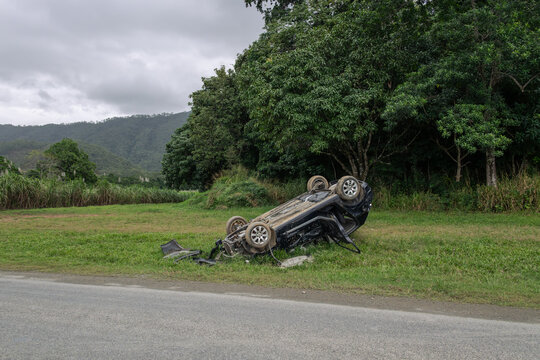 Overturned car on side of road in far north Queensland