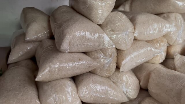 White refined sugar granulated in plastic bags pile