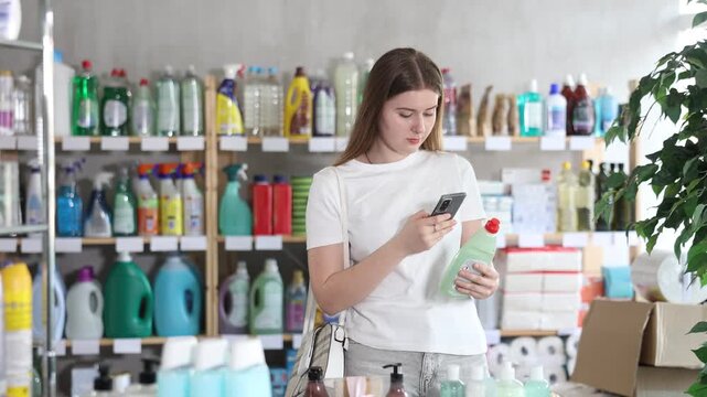 Girl buyer scans qr code on dishwashing soap label, uses link to get additional information on Internet 