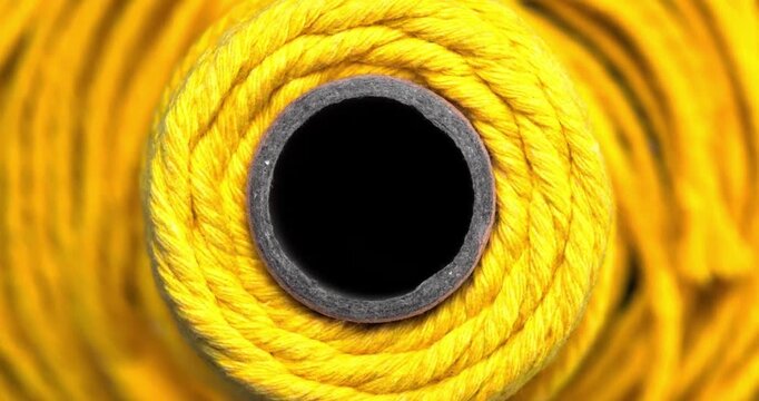 Top view close up of bright vibrant yellow rope spool texture background