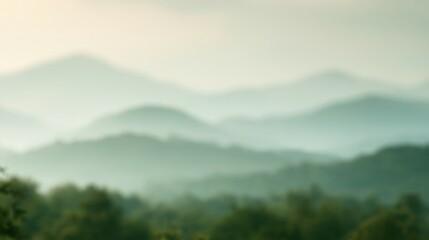 Obraz premium Fog covers green hills in the morning, creating a blurred view of the landscape with vast open space for imagination.