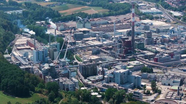 Vast industrial complex of Lenzing Plastics in Austria, showing the polymer and thermoplastic production facilities with smoking chimneys