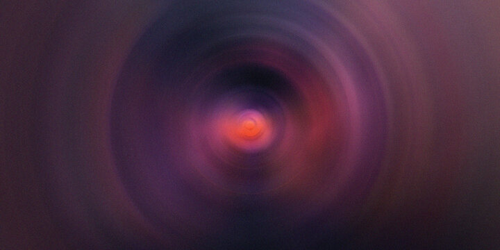 Abstract purple and orange radial blur effect creating a mesmerizing vortex suitable for modern graphic design and backgrounds.