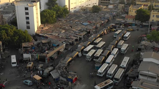 Aerial view of a bus depot in Dakar, Senegal. People commute on public transport in poor neighbourhood