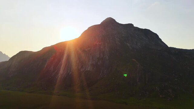 Drone trucks alongside a rugged Mulanje mountain as the setting sun traces the ridge, casting golden rays over green slopes and the valley below.