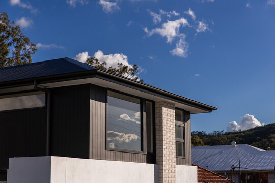newly built house front windows on a sunny day