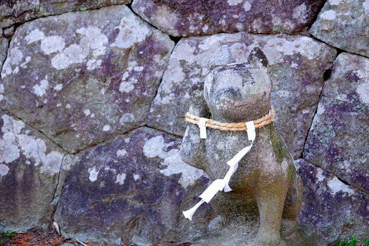 Stone Guardian Statue with Shimenawa and Shide at a Japanese Shrine