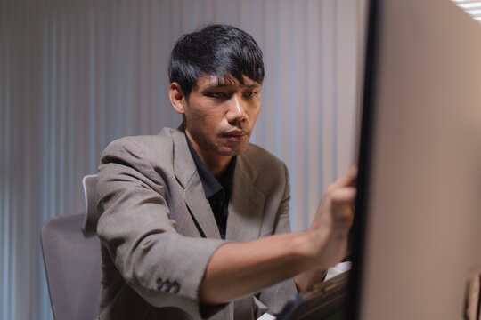Professional stock trader reviewing market charts with sticky notes across multiple monitors, laptop, and tablet to analyze price trends, plan trading strategies, and manage investment decisions.