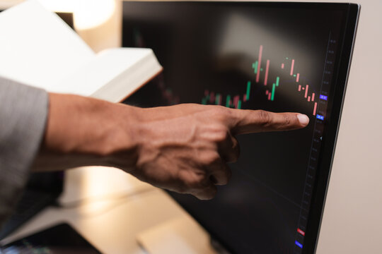 Professional financial analyst reviewing stock market charts across multiple screens using a tablet, laptop and calculator to evaluate price movements, technical indicators, and investment strategies.