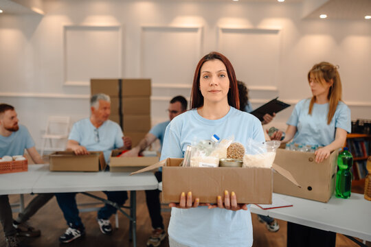 Volunteer woman holding food donation box for charity
