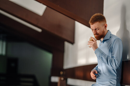 Businessman drinking coffee during office thinking break
