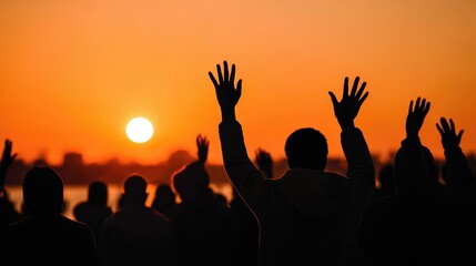 Fototapeta premium Dramatic silhouettes of a protest crowd raise their hands at sunset. Glowing orange sky and strong backlighting evoke unity, resistance, and activism.
