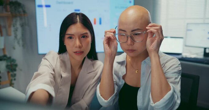 Young Asian business colleagues discussing project on computer at office. Corporate teamwork meeting, marketing report analysis, strategy planning development, professional manager advice concept.