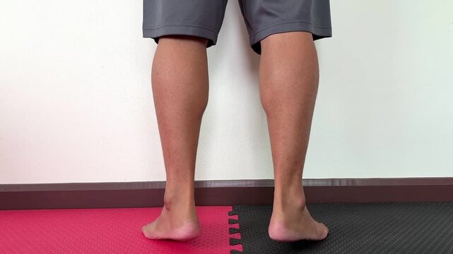 Close up , legs calf body weight workout on the padding , white background , video.