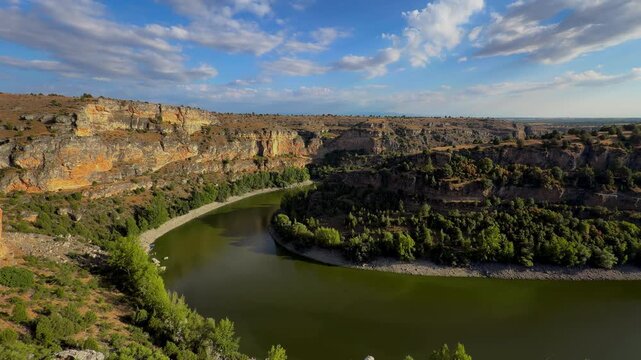 Hoces del Duraton river meander canyon view, Segovia Spain. Wide panorama of horseshoe bend, limestone cliffs and blue sky. High quality 4k footage