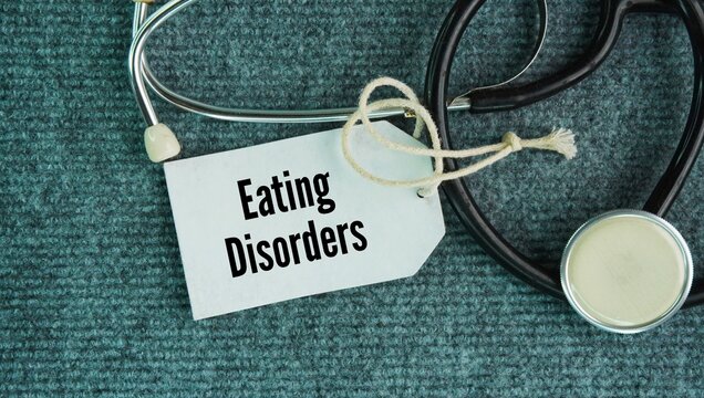 Stethoscope and paper label that says Eating Disorders are Involve severe disturbances in eating habits and body image. Examples include anorexia nervosa and bulimia nervosa.