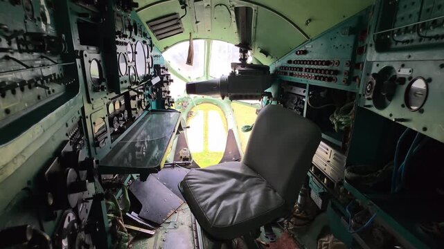 Interior view of vintage aircraft cockpit showing pilot seat instrumentation panel controls dials switches gauges complex machinery aviation technology history