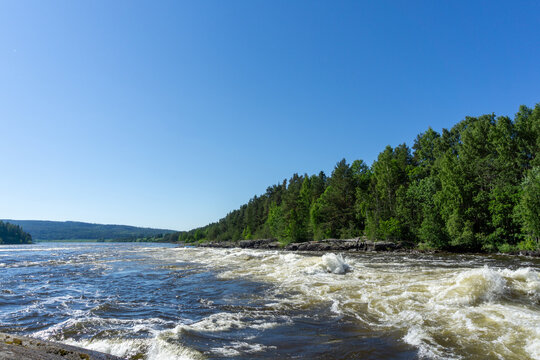 Glomma river rapids flowing through forest in Norway