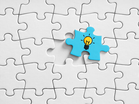 Blue jigsaw piece with light bulb finding solution