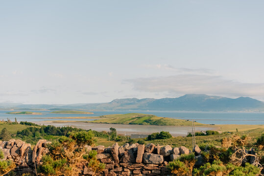 Scenic view of Clew Bay and the coastal village of Murrisk, surrounded by green hills and mountains along Ireland Wild Atlantic Way - County Mayo, Ireland - 31 August 2026.