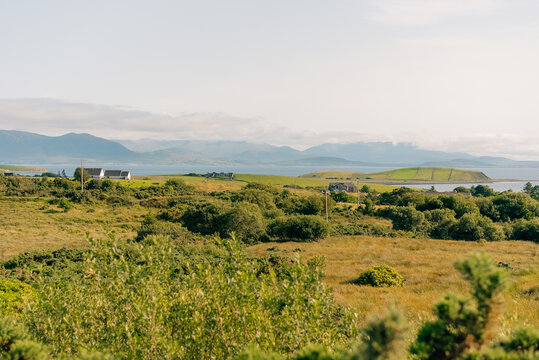 Scenic view of Clew Bay and the coastal village of Murrisk, surrounded by green hills and mountains along Ireland Wild Atlantic Way - County Mayo, Ireland - 31 August 2026.