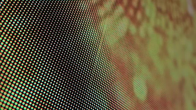 Macro close-up view of vibrant LED screen pixels in grid pattern, displaying abstract light and color, showcasing digital technology and modern display detail slow motion