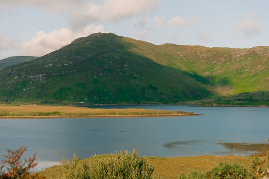 Scenic view of Clew Bay and the coastal village of Murrisk, surrounded by green hills and mountains along Ireland Wild Atlantic Way - County Mayo, Ireland - 31 August 2026.