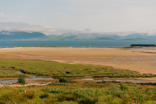 Scenic view of Clew Bay and the coastal village of Murrisk, surrounded by green hills and mountains along Ireland Wild Atlantic Way - County Mayo, Ireland - 31 August 2026.