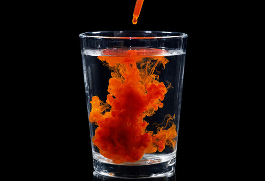 Methyl Orange Solution Dropping into Water Creating Colorful Swirls - Chemistry Diffusion Abstract Photography on Black Background