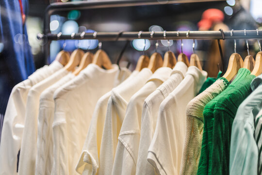 White and Green Knitwear on Boutique Clothing Rack