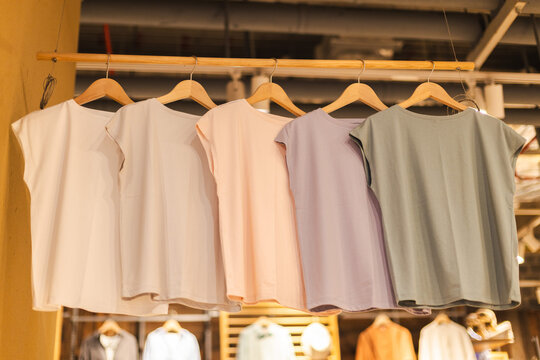 Pastel Sleeveless Tops on Wooden Hangers