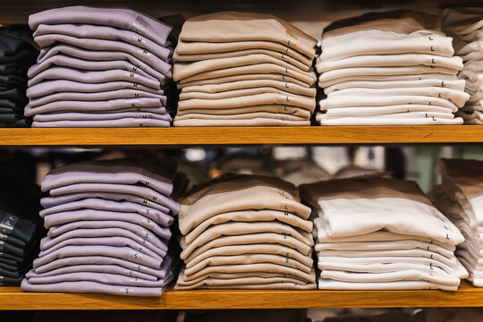 Folded Pastel and Neutral Clothing Stacks on Retail Shelves