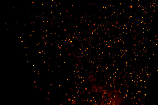 Warm embers drift across a deep black void