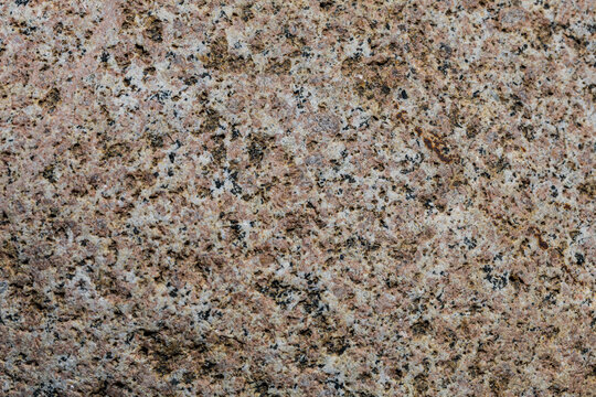 Granite surface with speckled brown and black minerals