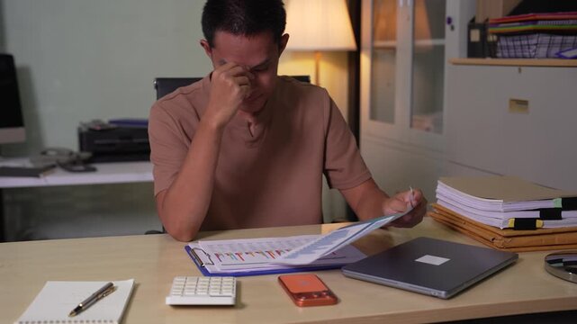 stressed asian businessman working in the office. Businessman thinking too much work concept in the office.