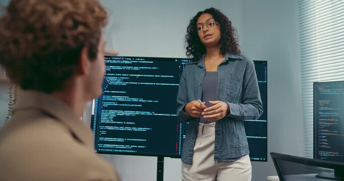 Diverse team software developer present coding on screen to colleague at office. Mentor coaching program leader, Creative startup teamwork discussion, Artificial intelligence system workshop concept.