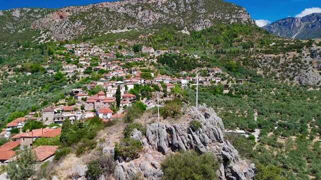 Scenic aerial shot of a traditional village surrounded by olive groves in amfissa, greece