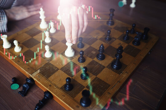 Black and White chess with player, Businessman and Businesswoman shaking hands after end game of thinking strategy to moving chess figure in competition with opposite player and planning.