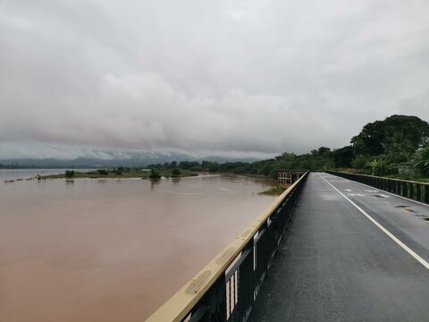 Khong river view with bridge on dim sky background