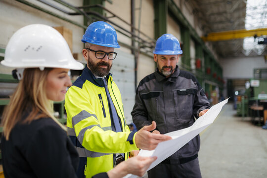 Engineering manager and mechanic worker doing routine check up in industrial factory