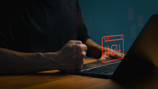 Frustrated man clenching fist at laptop computer with glowing red 404 error website graphic. Concept of technology system failure, internet connection issue, or hacker cyber attack.