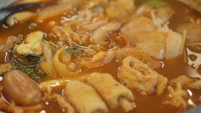 Korean spicy stew boiling in metal pot for meal preparation.
