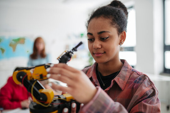 Girl student studying robotics while preparing for further education.