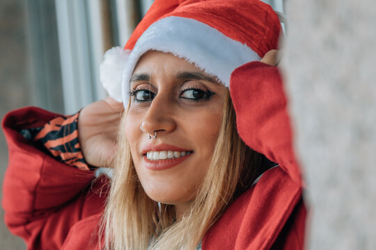 Happy woman with headphones on gray background. Christmas music