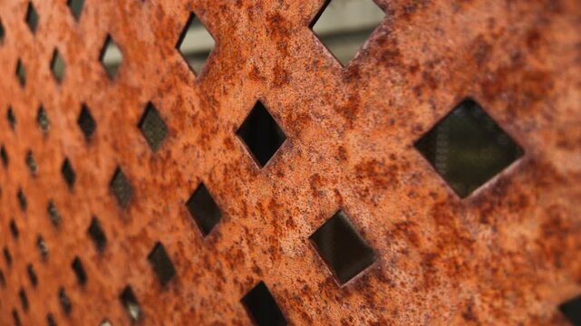Rusty perforated metal sheet with diamond pattern