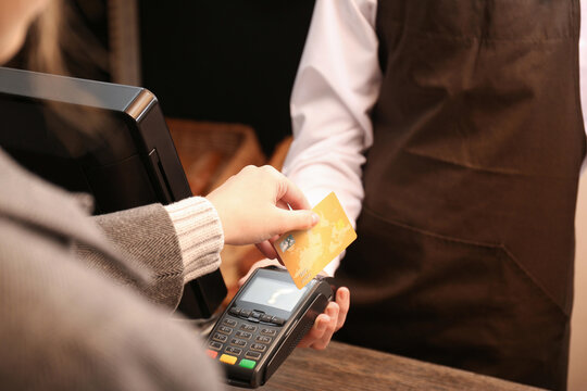 Customer paying with a contactless chip credit card at a store point of sale terminal